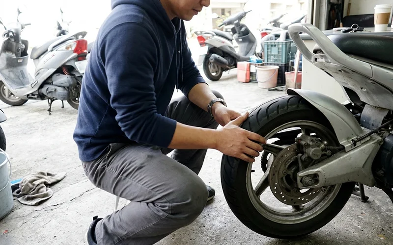 Checking a scooter's tyre and brakes before renting