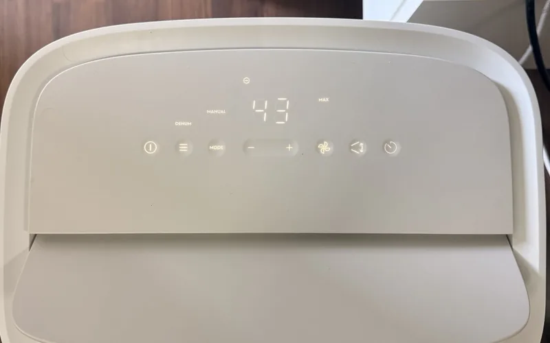 A dehumidifier control panel showing 43 per cent relative humidity in manual mode