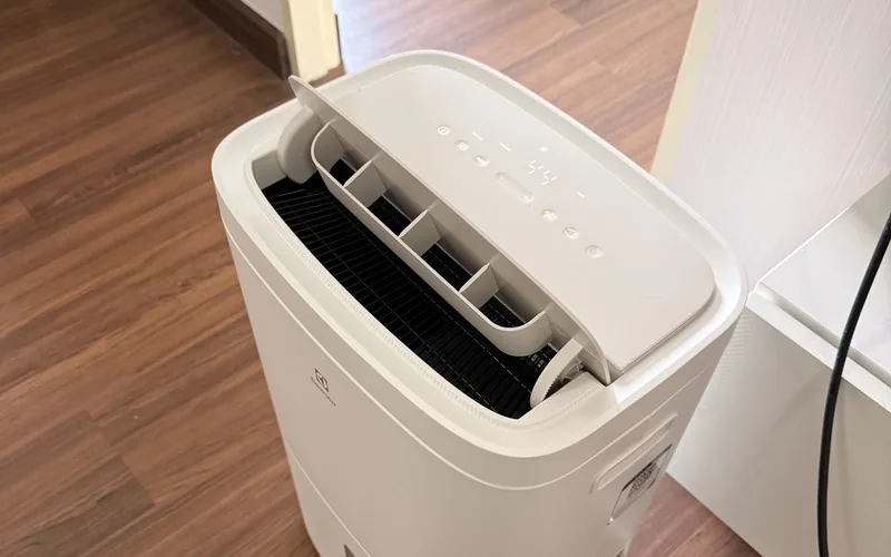 A portable Electrolux dehumidifier running on the wooden floor of a Chiang Mai condo