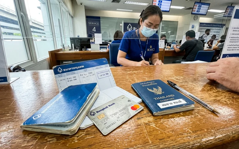 A new Thai bank book and debit card on a bank counter
