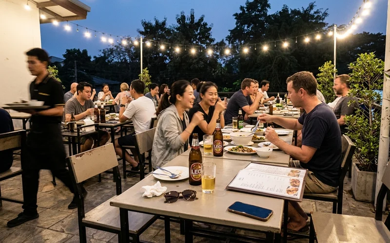 An outdoor dining terrace in Chiang Mai at dusk during cool season
