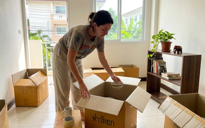 Unpacking boxes in an empty Chiang Mai apartment