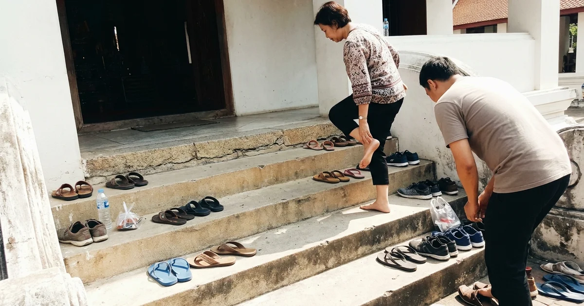 Visitors removing shoes at the entrance to a Chiang Mai temple